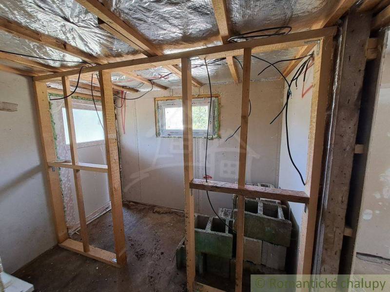Interior renovation, wooden frames, and a cabin. Construction materials and electrical installations are visible.