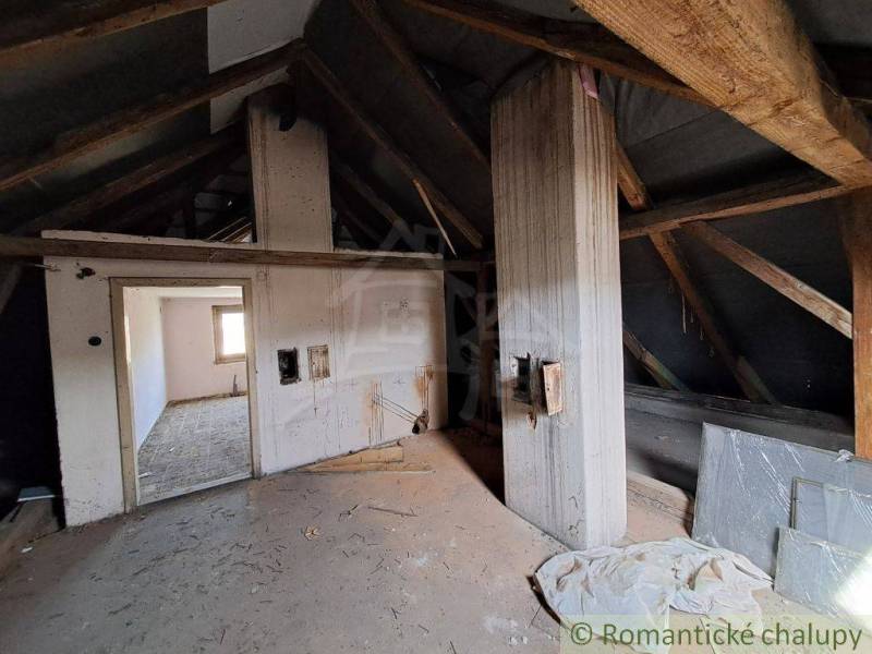 Attic and family house with wooden beams and a bright spacious interior for renovation.