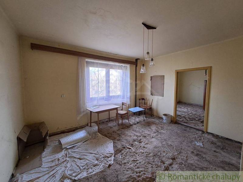 Empty room, chairs and a table by the window, yellow walls, family house.