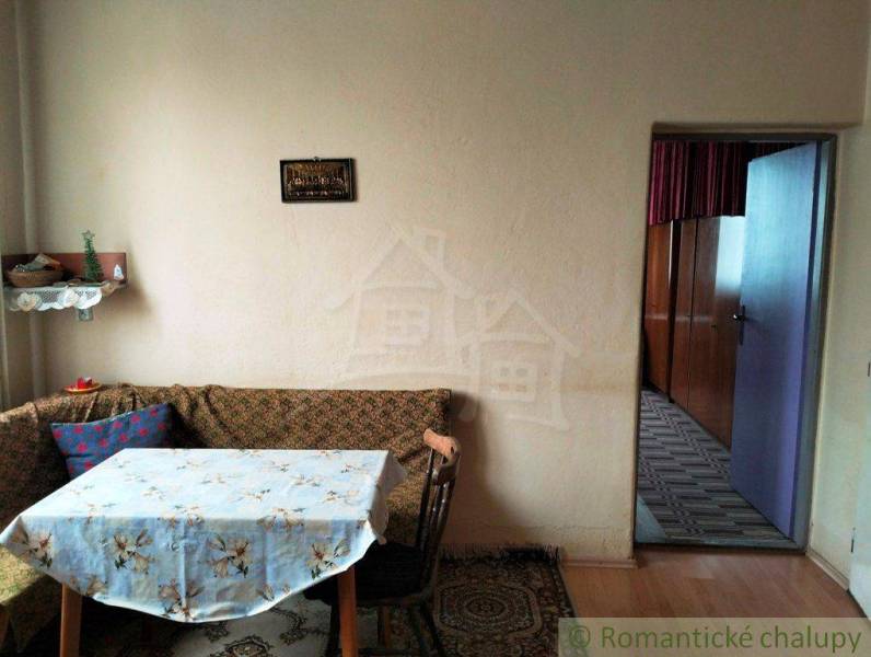 A family house with a rustic interior, retro furniture and decor, dining table in the corner.