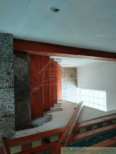 Staircase with railing in a family house, door, wall, and ceiling. Thermal insulation.
