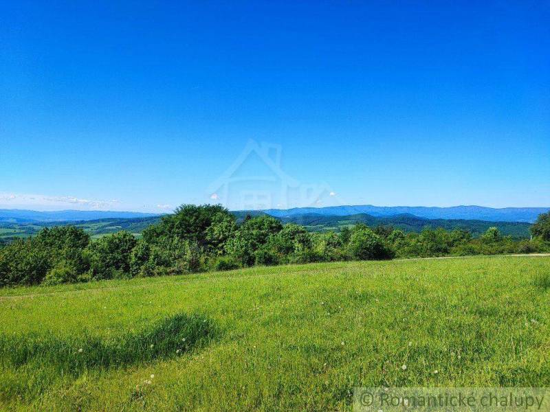 Beautiful countryside, green meadows and gardens with views of distant mountains.