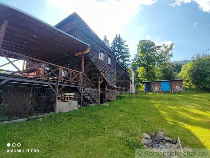 A wooden family house in nature with a terrace, lawn, and surroundings offering relaxation.