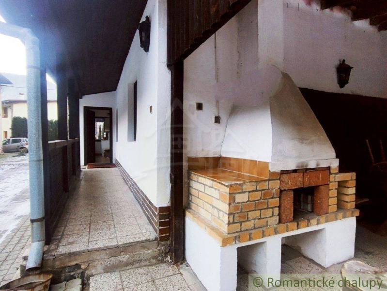 A family house with a terrace and a fireplace offers outdoor relaxation and comfort.