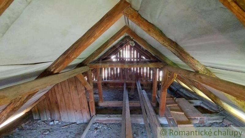 Attic with old wooden beams in the roof structure of a family house.