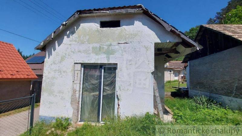 An older family house with land, renovation, natural surroundings, and sunny weather.