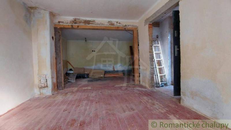 Interior of a family house with renovation, wooden floor, ladder, empty rooms.