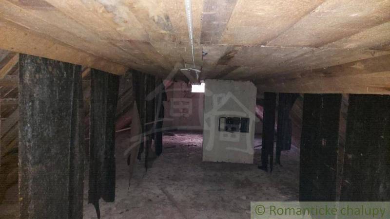 The attic of a family house with wooden beams, suitable for renovation.