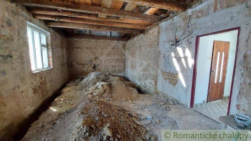 Renovation of a family house, bare walls and floor, window, door to a bright room.