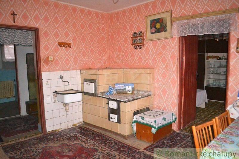 Retro kitchen with a stove, sink, and decorations in a family house.