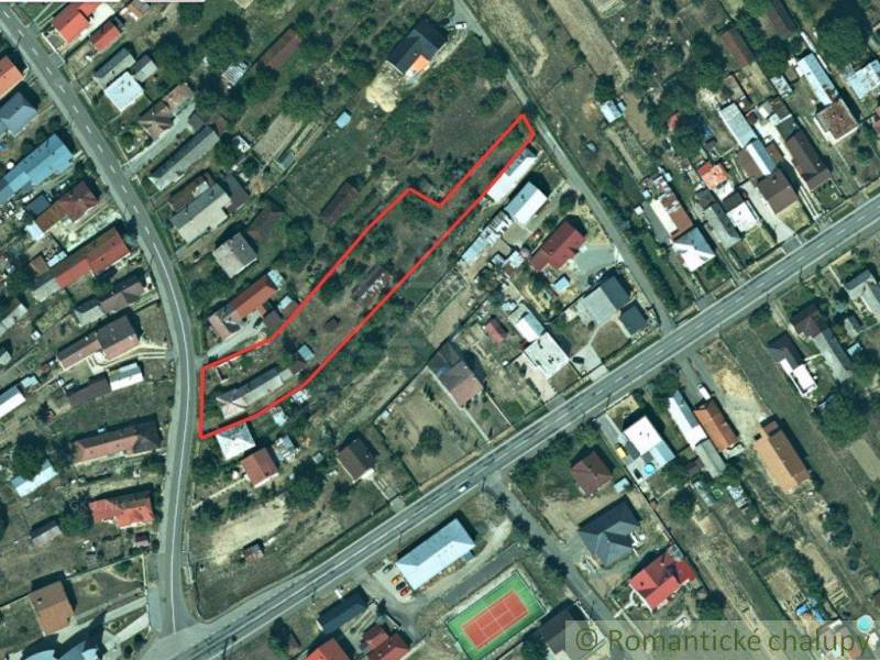 An aerial photograph shows an urban area with houses, surrounded by roads and a playground.