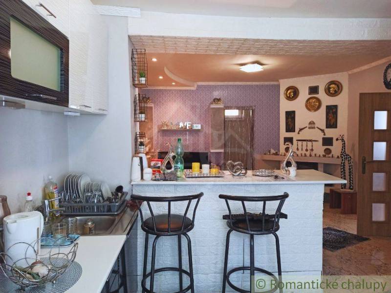 Interior of a family house: kitchen, bar stools, wall decorations.