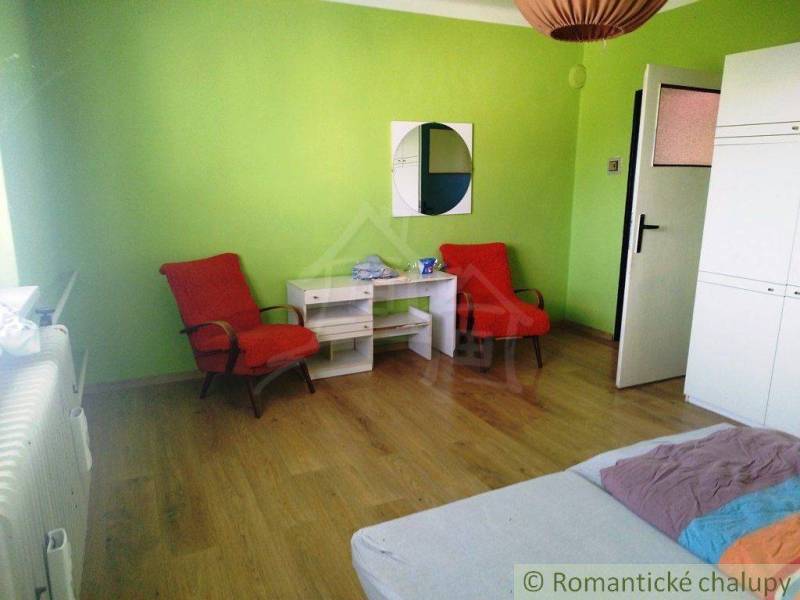 A room with gym furniture, green walls, wooden floor, family house.