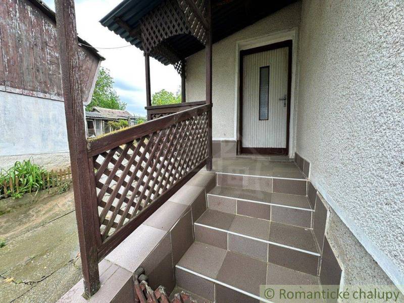 Entrance stairs with wooden railing leading to a family house.