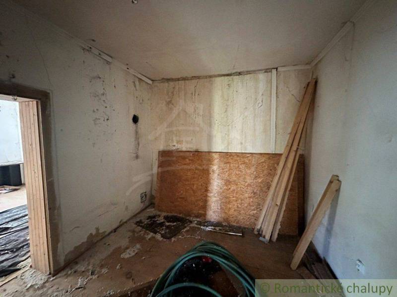 Older interior for renovation, cottage with OSB boards and wood.