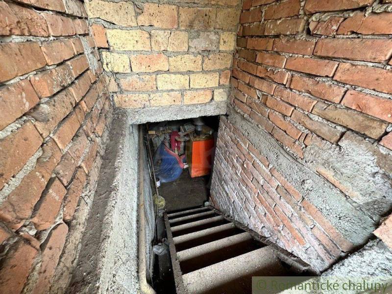 Old brick stairs leading to the basement and a family house, boiler, bricks.