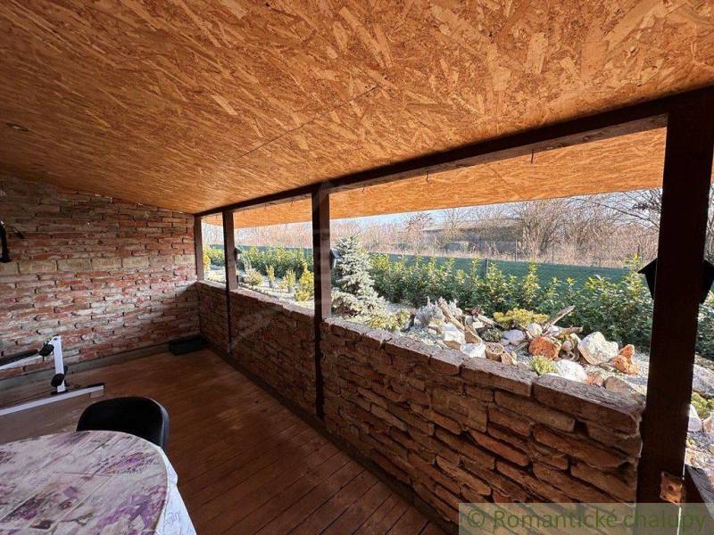 Family house with an antique space, brick walls, wooden roof, view of the garden.