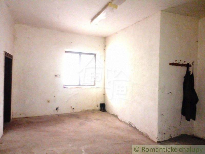 Abandoned room, old coat rack, window. Potential for renovation in a family house.