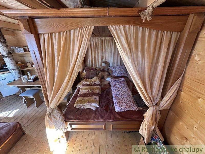 Rustic interior with a bed, curtain, wooden furniture, family house.