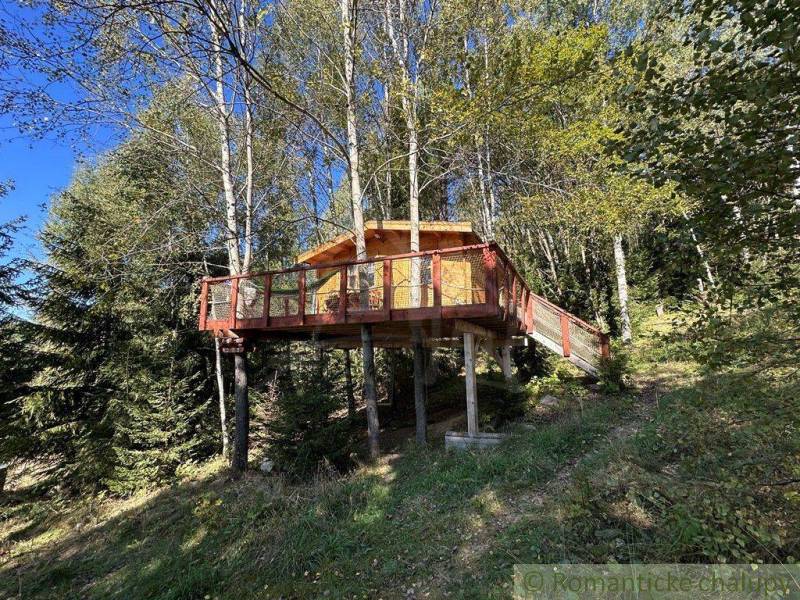 A wooden treehouse in a forest setting for family getaway and relaxation.