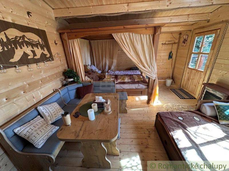 A family house with a wooden interior, comfortable seating, and a cozy atmosphere in a romantic cottage.