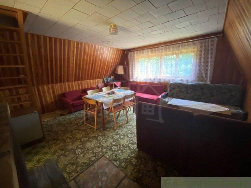 Living room in a wooden house, old furniture, carpets, and curtains. Family house.