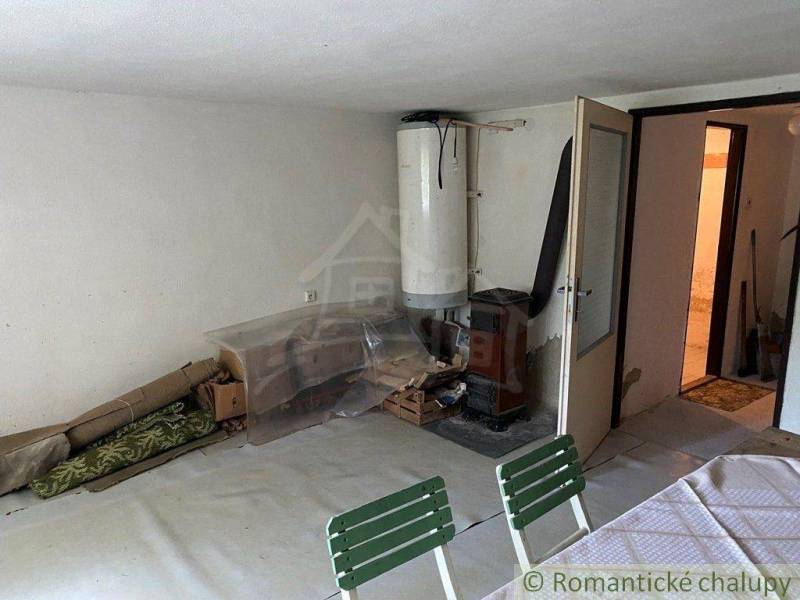 Dining room of a family house with a boiler and furniture, used for storage purposes.