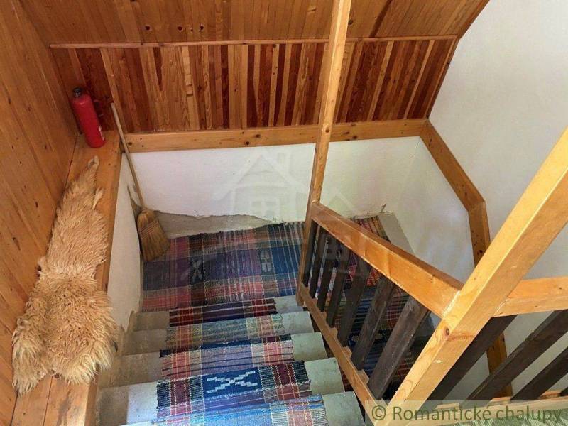 Wooden staircase in a traditional style, connected with carpets in a family house.