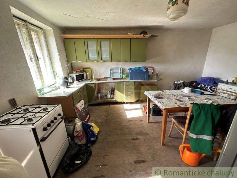 Country kitchen, stove, green cabinet, wooden floor, dining table, family house.