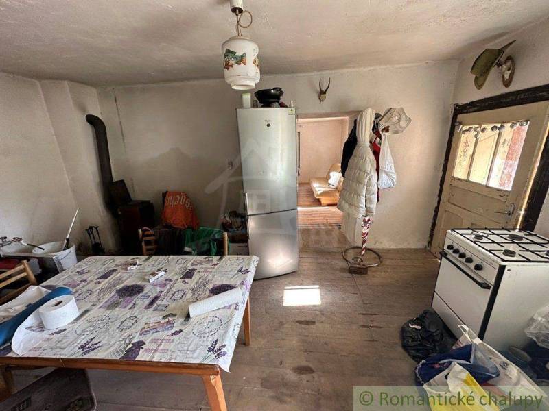 A kitchen with a wooden floor and furnishings, suitable for a family house.