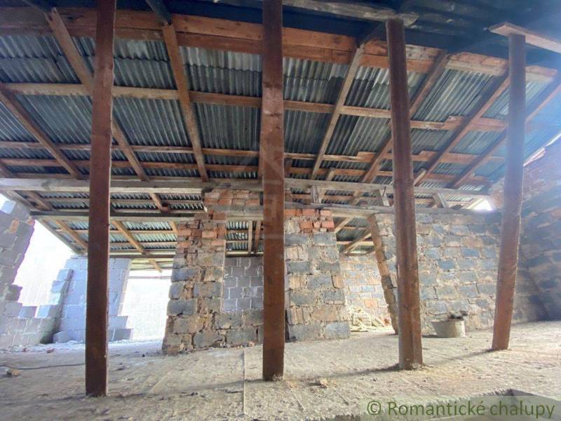 A building with wooden beams and concrete walls, in the roof construction of a family house.