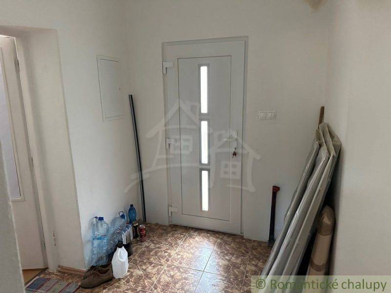 Entrance hall with white doors and stored materials in a family house.