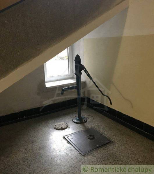 Under the staircase, there is a water pump next to the window, ideal for a 2-bedroom apartment.