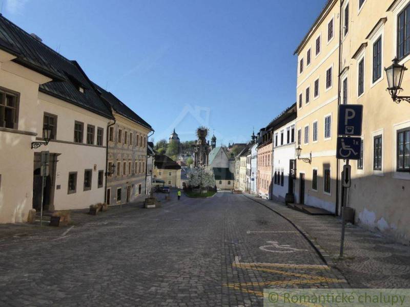 The historical center of Banská Štiavnica with a church, cobblestone streets, a family house in traditional style.
