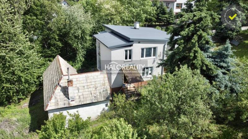 A family house in Nová Baňa surrounded by greenery and trees in a peaceful location.