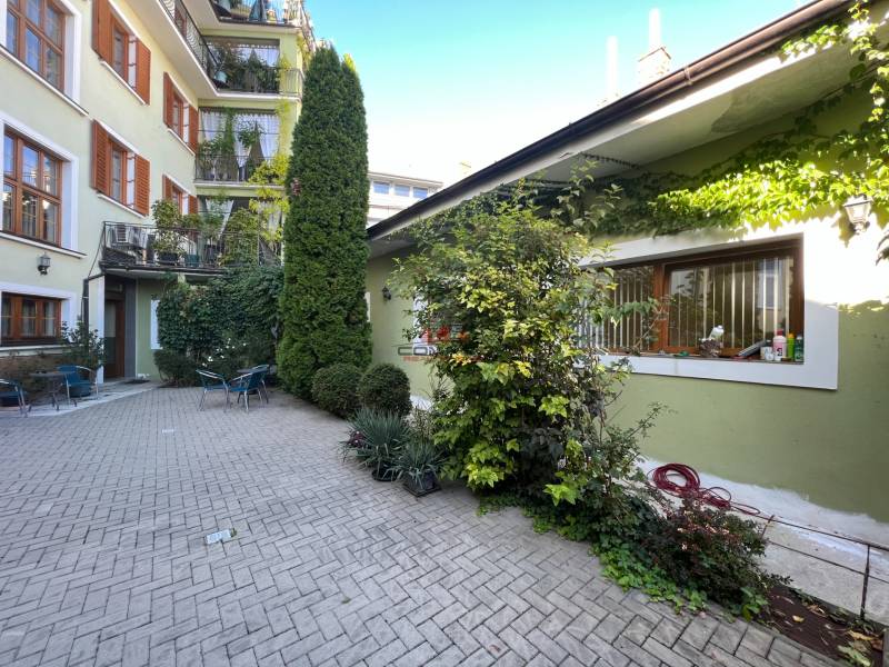 Building with greenery on Nitrianska Street, outdoor offices and garden furniture.