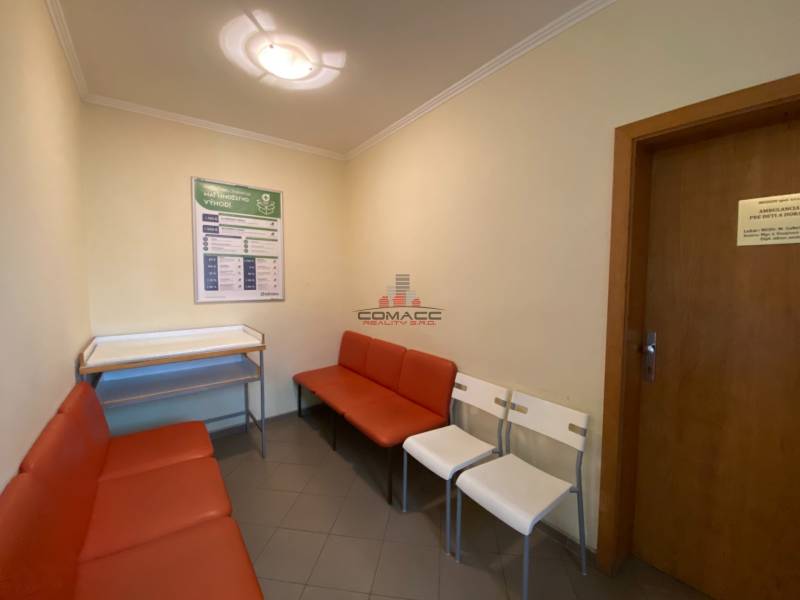 Waiting room in front of the office on Nitrianska Street with seating and an information board.