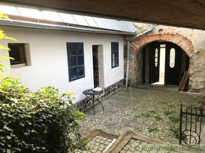 Stone courtyard with an arch, named **Roman** and Unique properties in a romantic style.