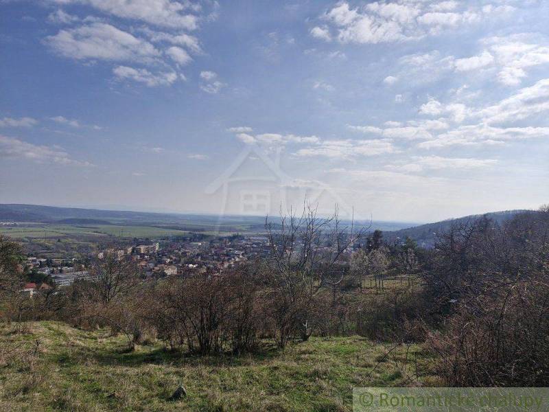 A view of a picturesque town in the valley, surrounded by nature and meadows. Family house.