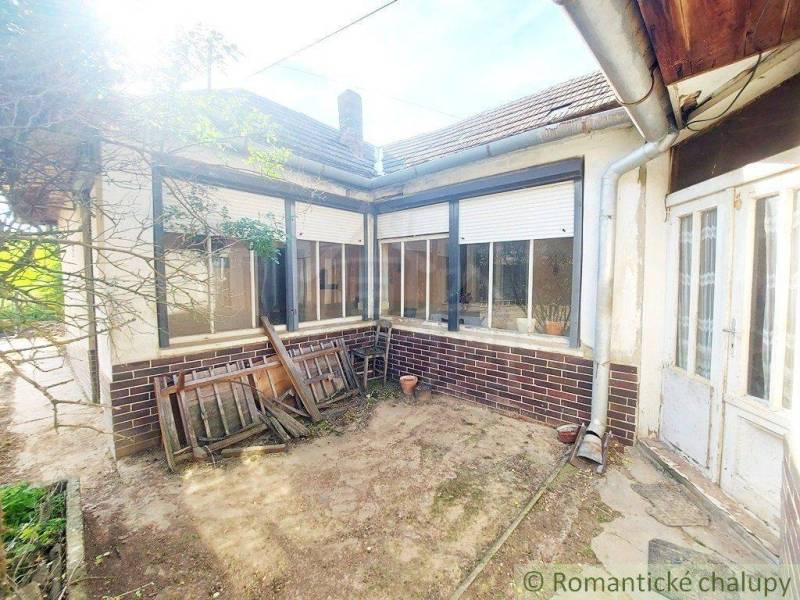 Courtyard of a traditional cottage with wooden doors and windows for romantic cabins.