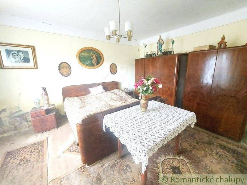 A room with a bed and wardrobes. A cottage with decorations creates a cozy atmospheric space.