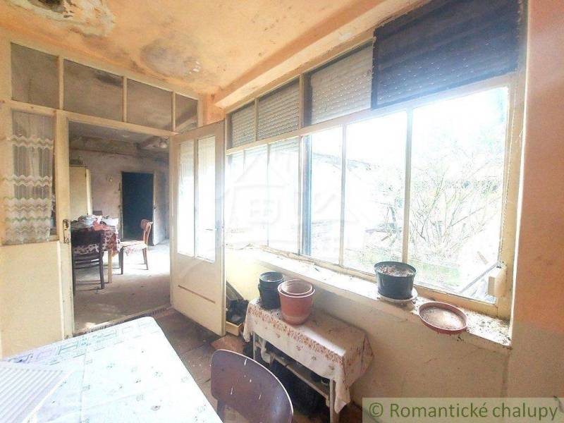 Interior, table, chairs, large windows, potted plants, romantic atmosphere, weekend cabin.