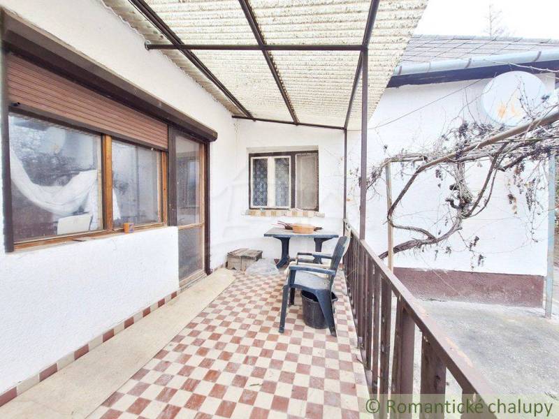 Spacious covered terrace with plastic furniture at the family house.