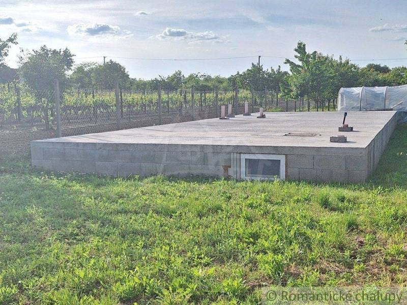 A building on a plain surrounded by vineyards and gardens, ready for the next project.