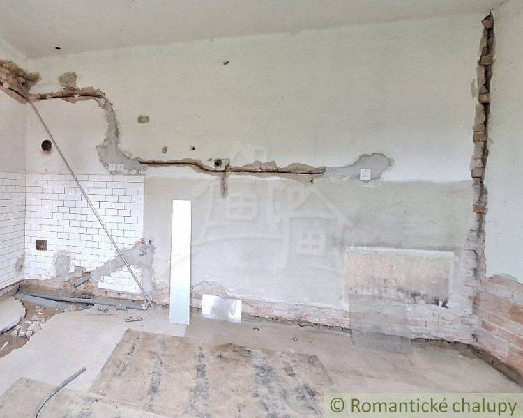 The shabby interior shows a construction site with exposed bricks and plaster, suitable for a cottage renovation.