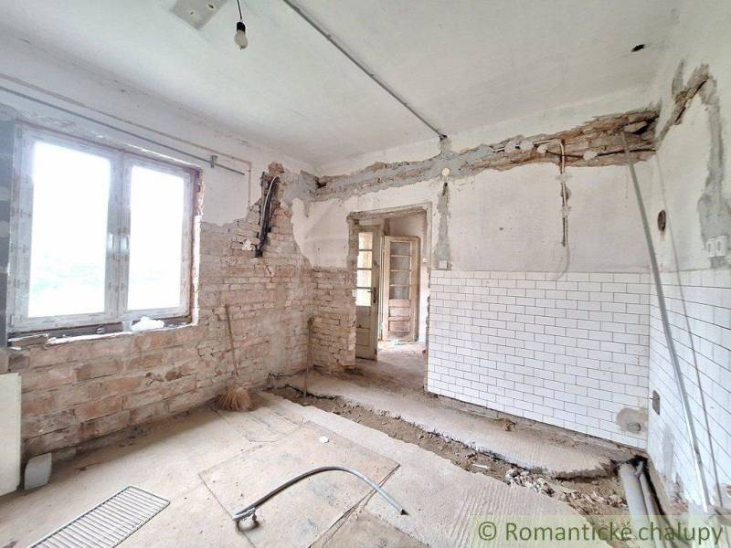 An unfinished renovation of a cottage with exposed walls and an old design ready for renewal.