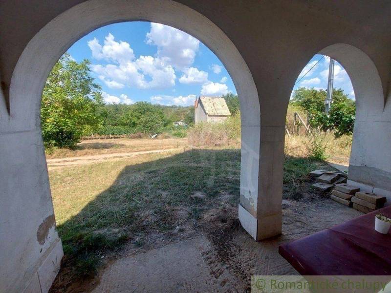 The arched veranda offers a view of the landscape and unique properties in the area.