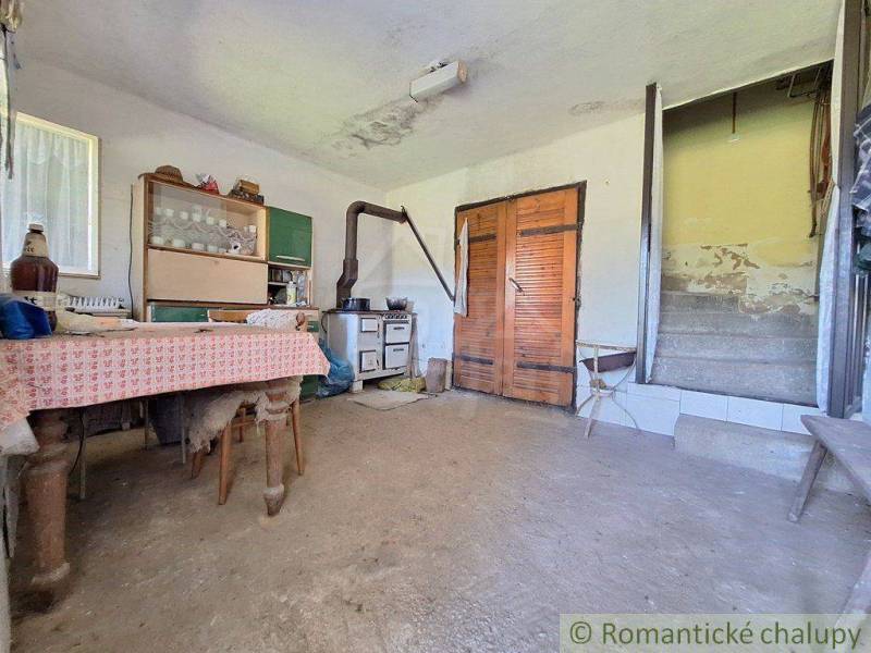 A rustic interior with an old stove and wooden furniture is offered by Unique Properties.