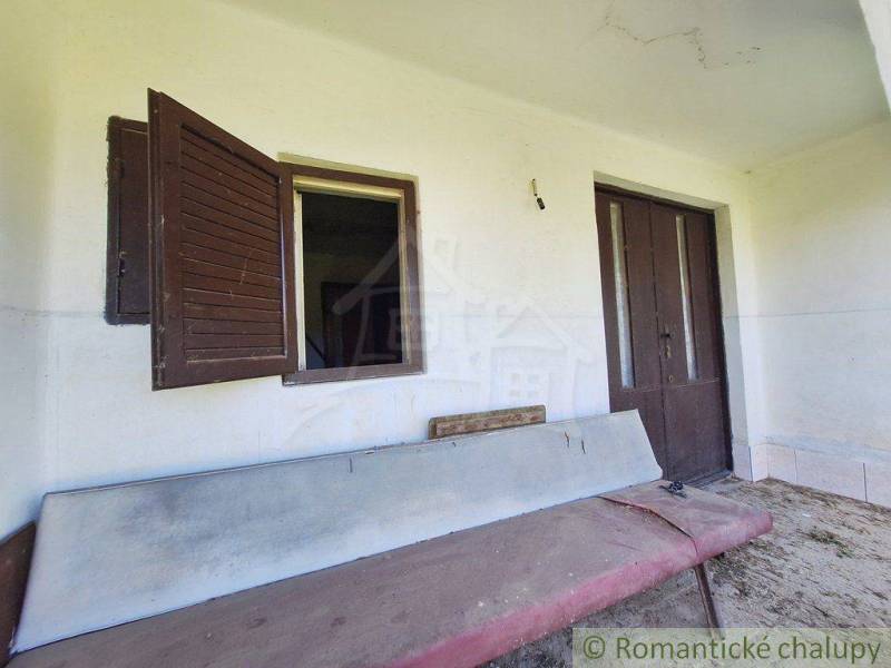 Old wooden window and door on the terrace with an old bench in Strange properties.