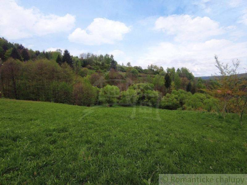 Green meadows and hills provide a peaceful setting for a family home in nature.